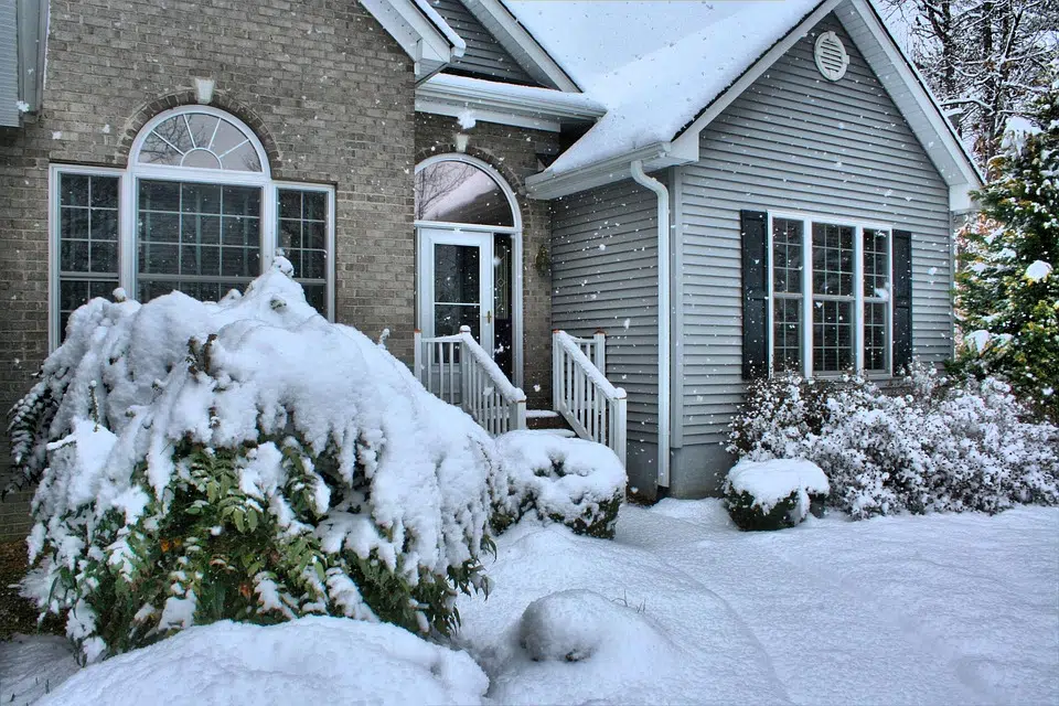 House and front yard covered in snow