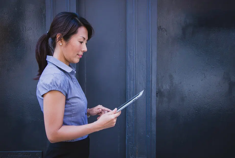 A woman looks at an iPad