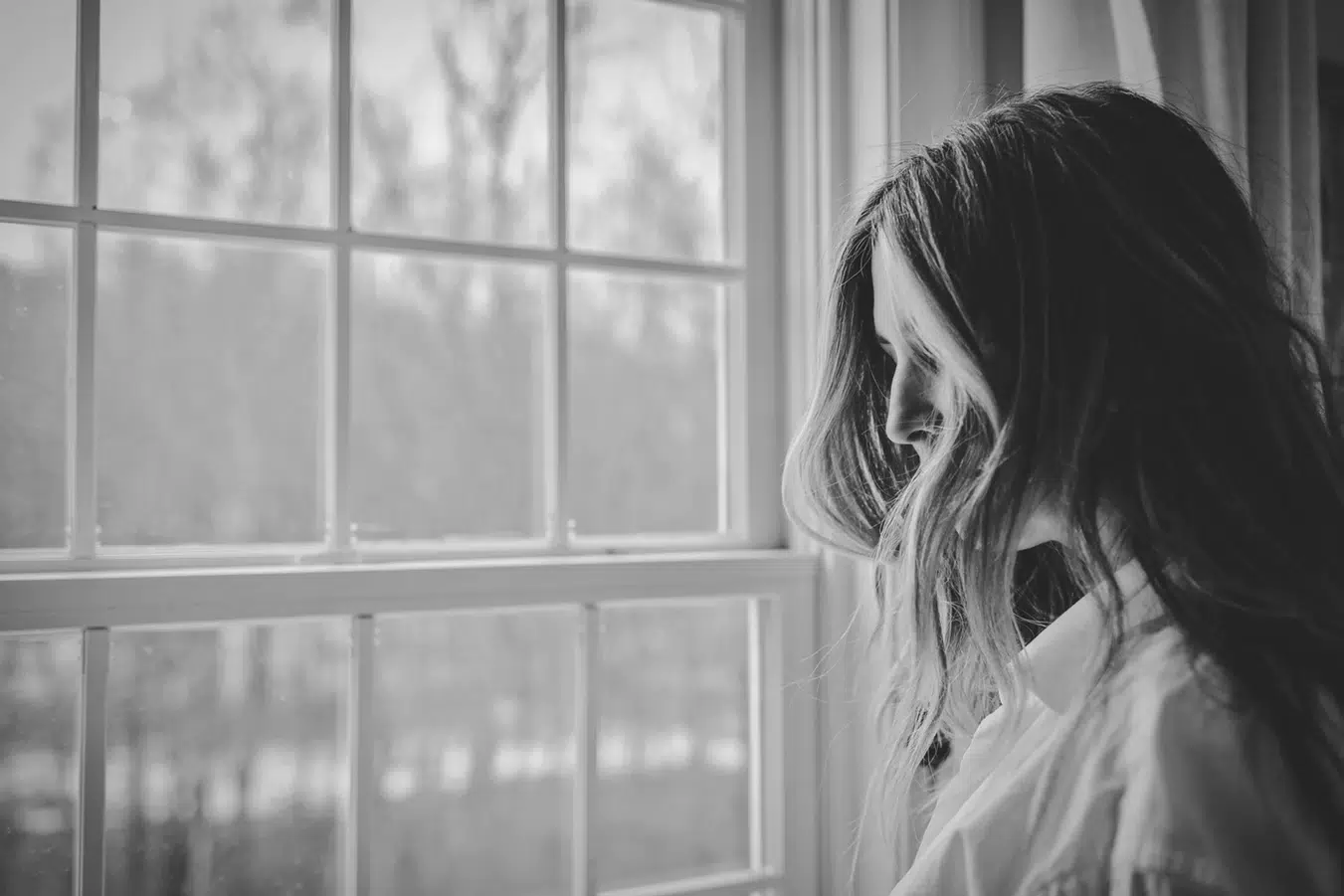 woman staring out a window