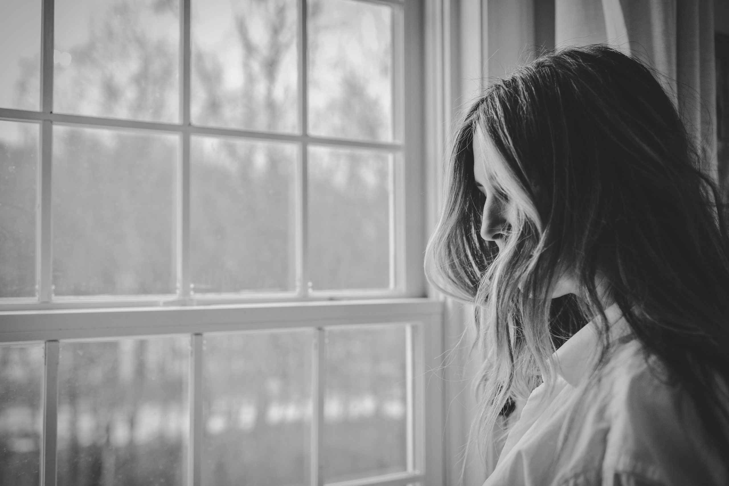 a woman looking out a window