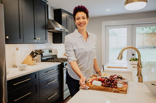 woman with snack board in kitchen