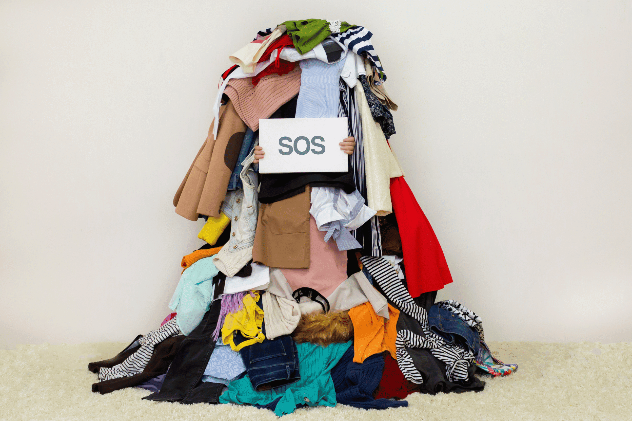 Working mom overwhelmed by a pile of laundry.