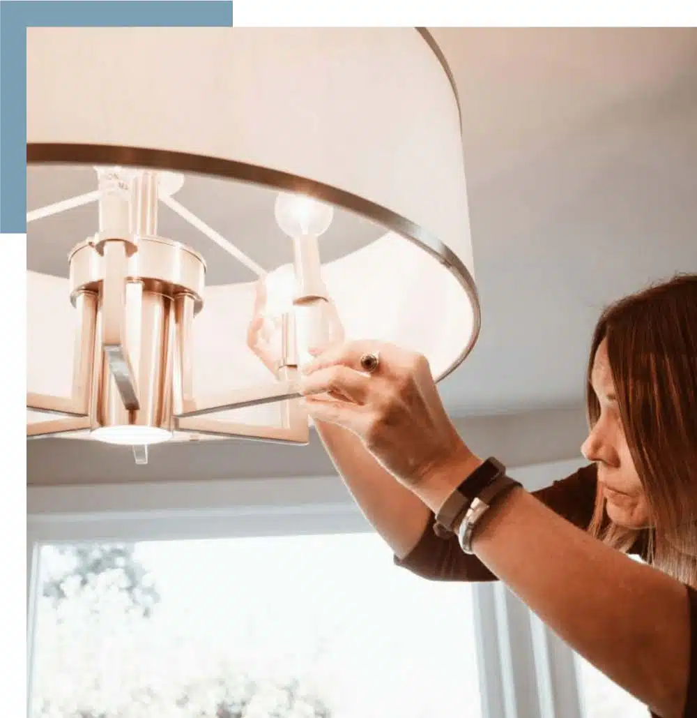 Female personal assistant changing lightbulb 