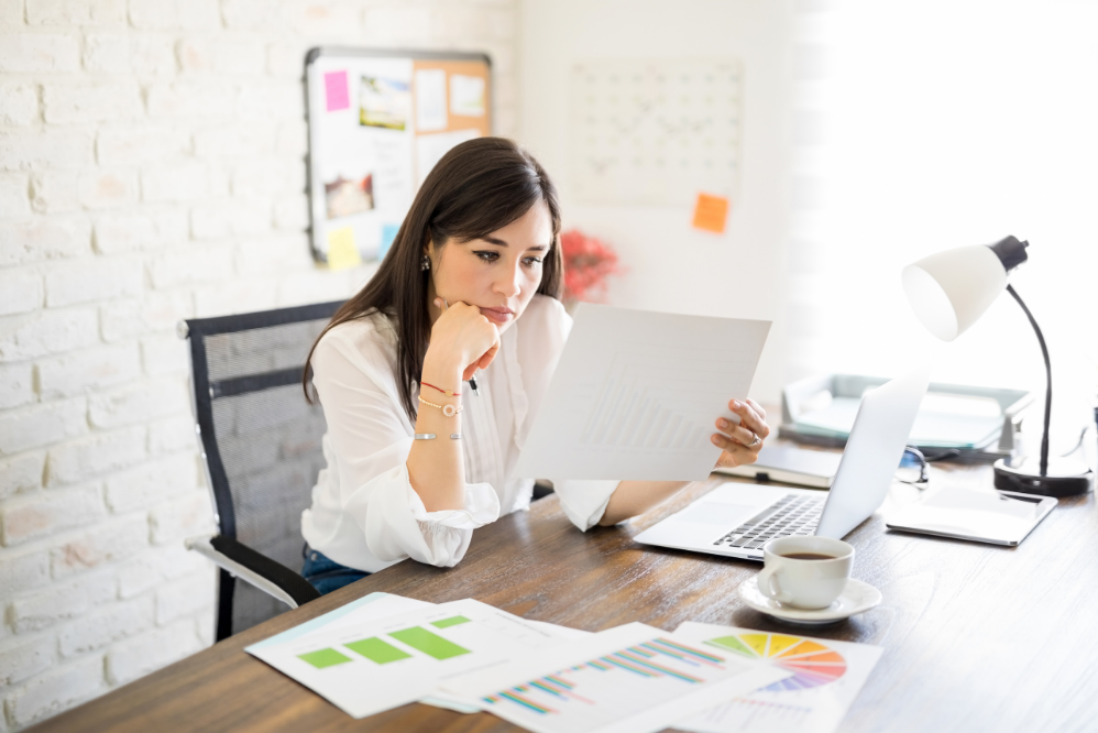 Woman looking at paper and analyzing documents