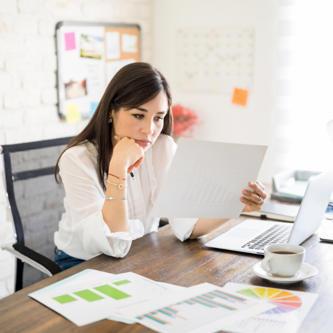 Woman looking at paper and analyzing documents